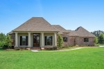 Polo Farms Exterior with brick and wood siding. Large entry doors with massive door light. Inviting front porch that looks out onto the massive yard. Private side entry garage.