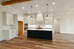 The painted kitchen island is in a different color from the remaining kitchen cabinets.