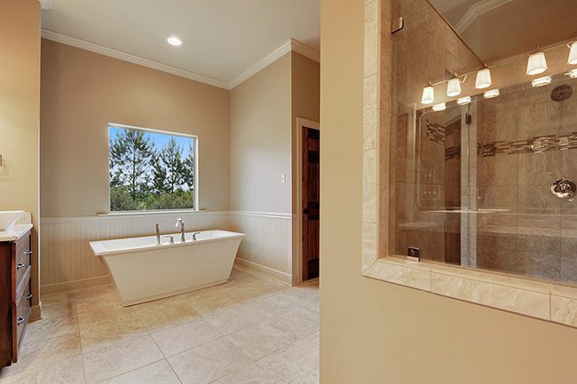Master bath with custom shower window giving you an open and airy feel while in the shower. This master bath has a clean look with an elegant touch. Enjoy a long bath in the large soaking tub or a hot shower in the large walk in shower. All features in this master bath are top notch.