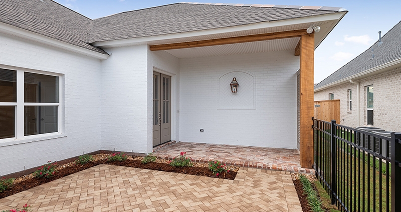 A beautiful spot featured here is this custom courtyard with brick pavers and nice landscaping.