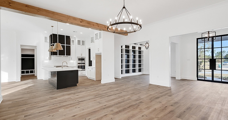 A farmhouse feel in this open floor plan home with a nice custom wood beam and fresh hardwood floors.