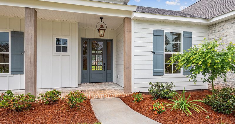 Covered front porch with real wood rustic columns welcomes you into this home.