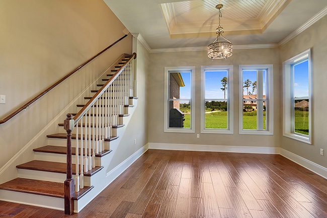 Sweeping staircase that leads into a spacious open living area.
