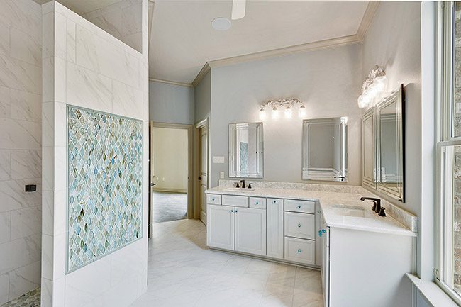 Custom mosaic tile as an added upgrade in the luxurious home.