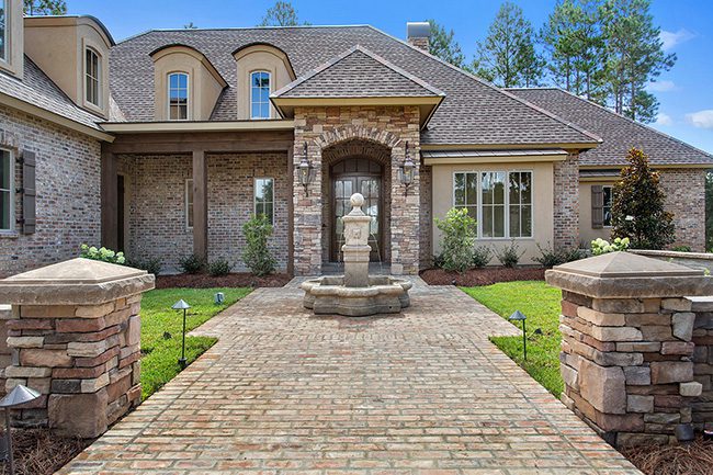 New custom built home close to New Orleans. Beautiful front entry with water feature. This home has a brick exterior with stucco accents.