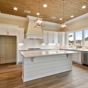 The kitchen boast a nice kitchen island with a nice ship lap accent. The kitchen island has an area for sitting.
