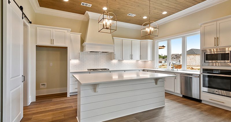 The kitchen boast a nice kitchen island with a nice ship lap accent. The kitchen island has an area for sitting.