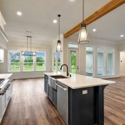 A nice overview of the open floorplan in this home. The house has a nice hardwood flooring throughout. The kitchen has an oversized kitchen island.