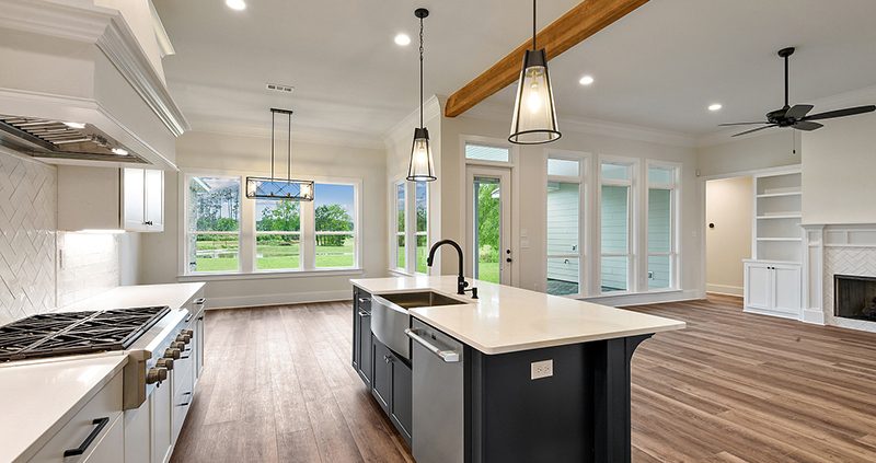 A nice overview of the open floorplan in this home. The house has a nice hardwood flooring throughout. The kitchen has an oversized kitchen island.