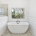 A large window offers a view of the serene, forested outdoors, complementing the bathroom's clean and peaceful design.