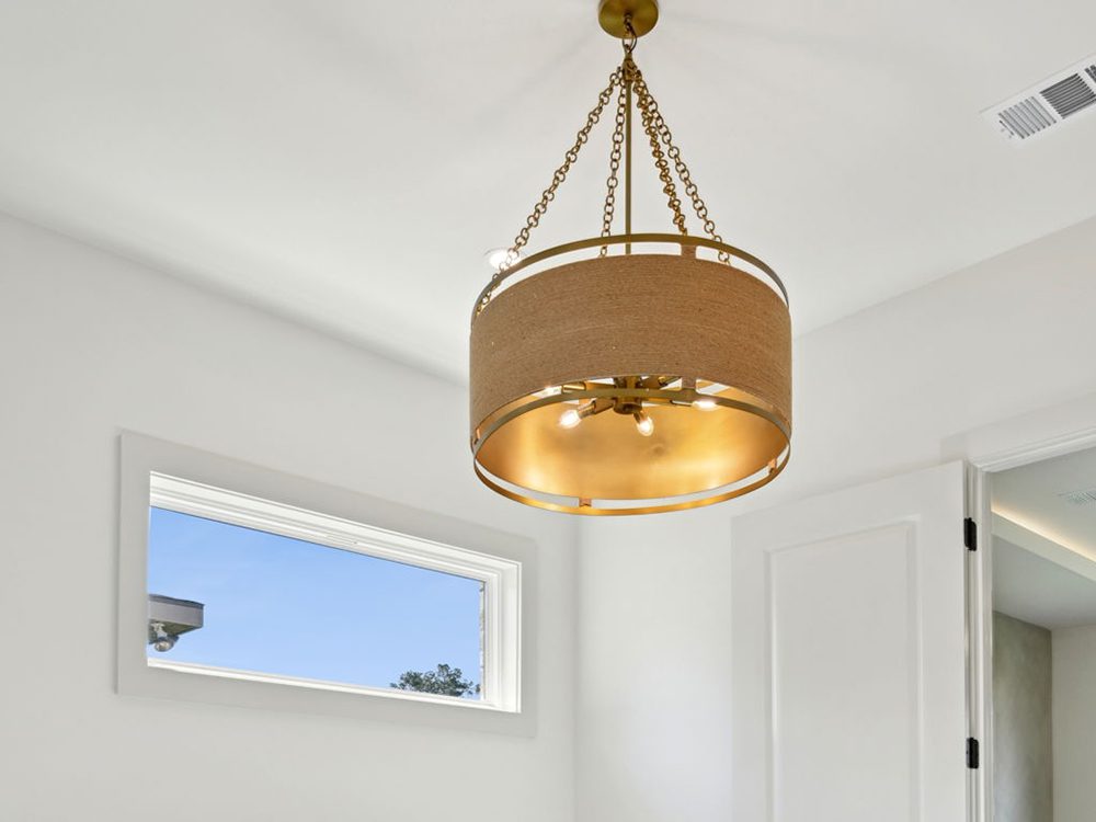 18-5040 Twin River Custom Lighting This sophisticated pendant light makes a bold yet balanced statement with its double-drum design. A warm, woven fabric exterior encircles a rich gold interior, casting a soft, golden glow that elevates the ambiance of the room.