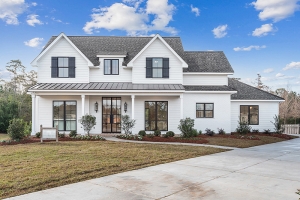 This custom home features a nice white exterior with black trim.