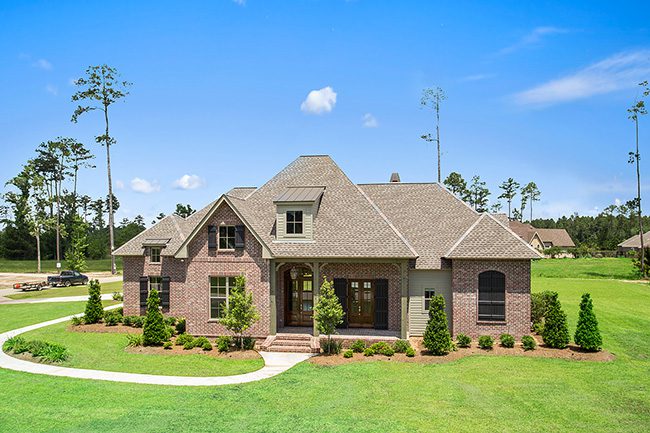 Upscale exterior with custom shutters and brick siding.