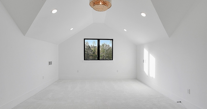Secondary bedroom with a unique ceiling that has recessed lighting and a custom chandelier.