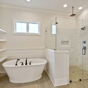 Private soaking tub in the master bathroom that has a window above. There is a lot of natural lighting in this master bathroom.