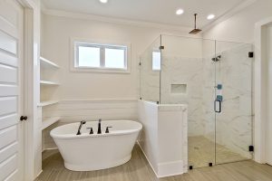 Private soaking tub in the master bathroom that has a window above. There is a lot of natural lighting in this master bathroom.