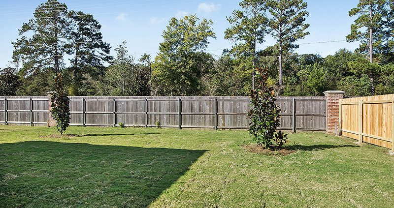 Private backyard featuring tons of grassy space for spending time outdoors. This yard has been landscaped and ready for its new owners.