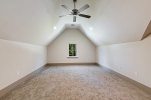 The bonus room has plush carpeting and recessed lighting in this flex room that can serve as a game room, media room, craft room or home office.