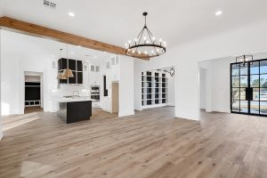 A farmhouse feel in this open floor plan home with a nice custom wood beam and fresh hardwood floors.
