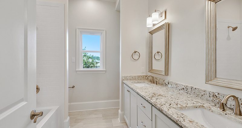 A nice secondary bathroom with a dual vanity with separate sinks.