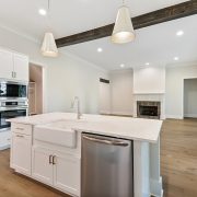 The kitchen island is the home to the kitchen sink and the dishwasher.